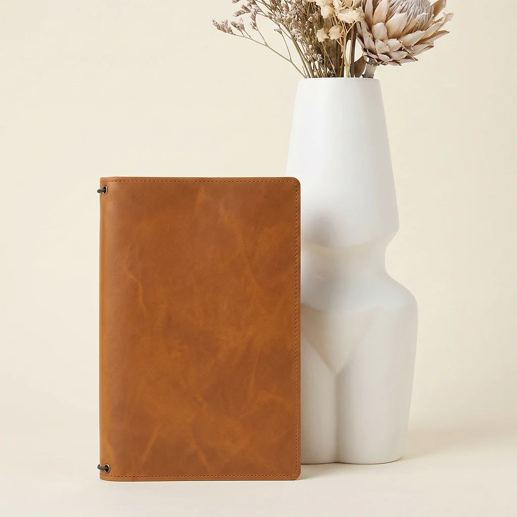 Genuine leather notebook folio with flexible elastic attachment system inside.