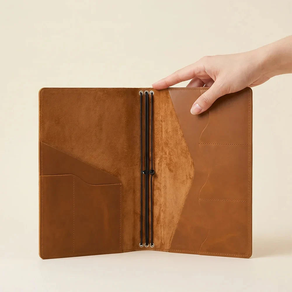 Refillable leather journal wallet with notebook elastics and practical inner pocket layout.