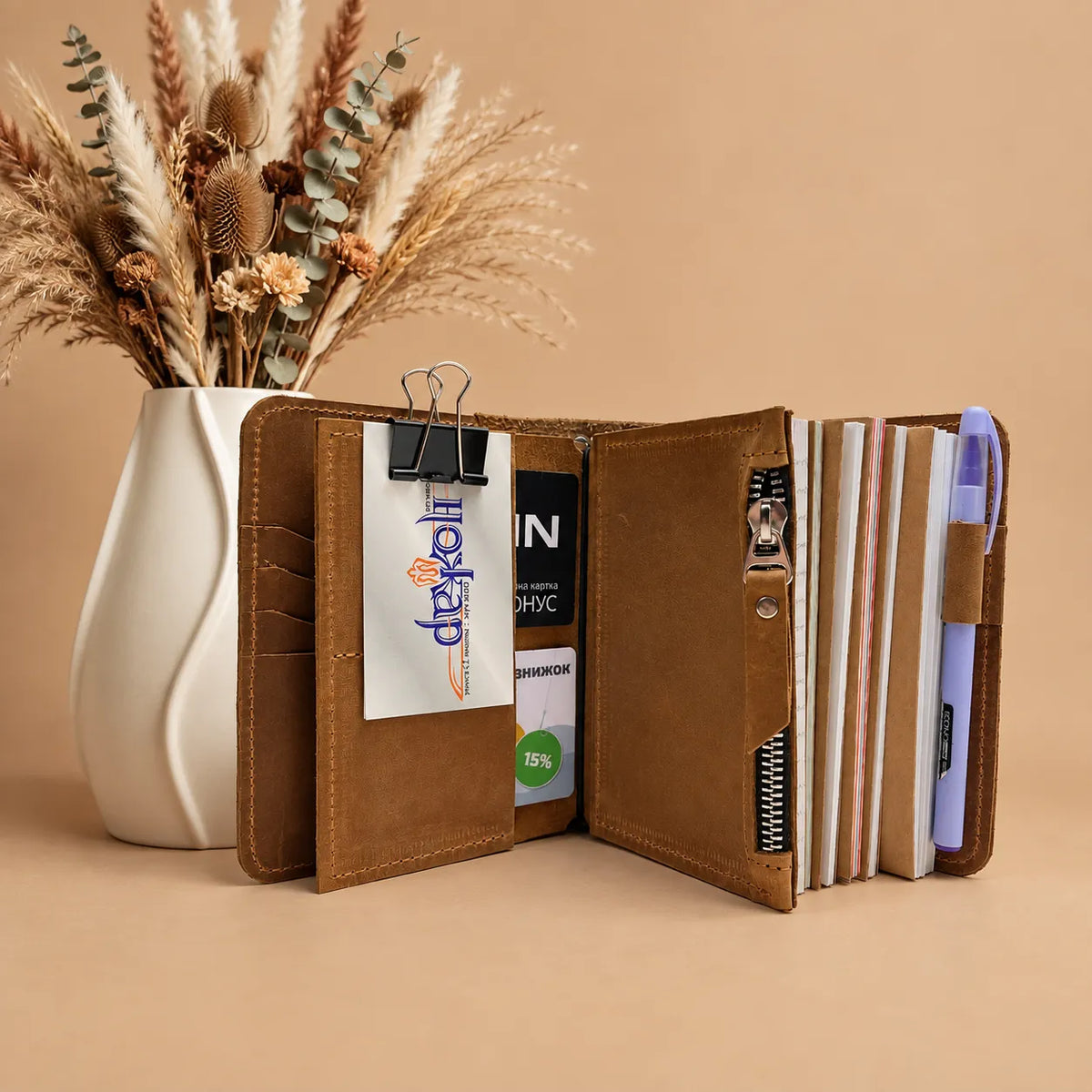 Handmade leather cover for notebooks with five elastic bands and inner pockets.