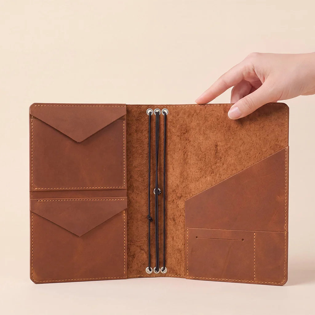Handmade refillable notebook cover featuring genuine leather, pockets, and sturdy elastic bands.