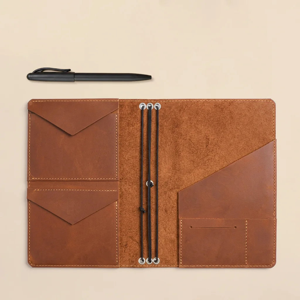Refillable notebook cover crafted from genuine leather with organized pocket layout inside.