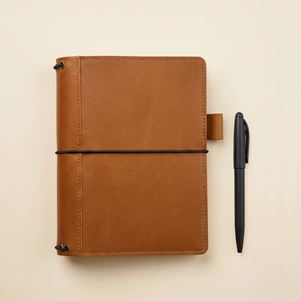 Handmade leather journal case with organized interior and refillable insert system