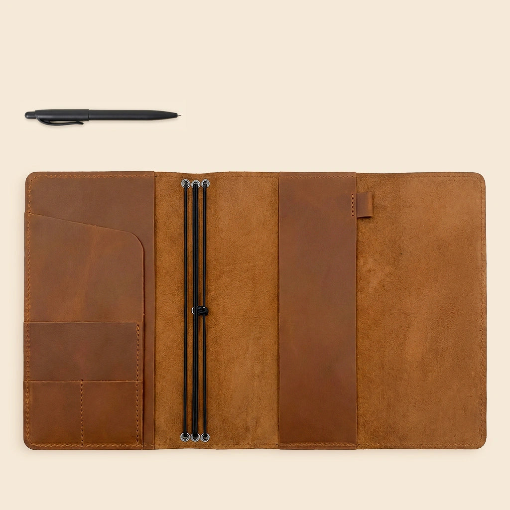 Refillable notebook holder handcrafted from genuine leather with thoughtful interior organization.