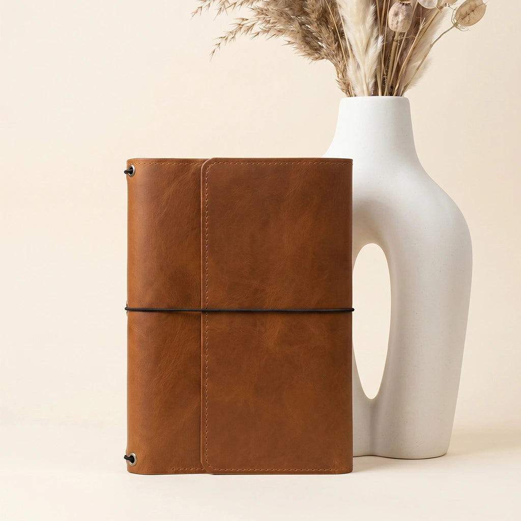 Leather notebook portfolio designed to keep writing supplies neatly arranged and protected.