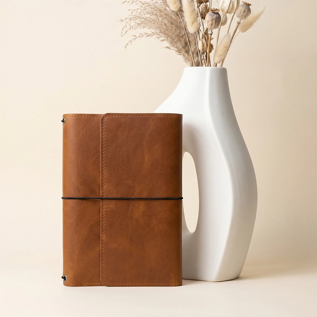 Leather notebook organizer with handcrafted finish and refillable notebook carrying system.