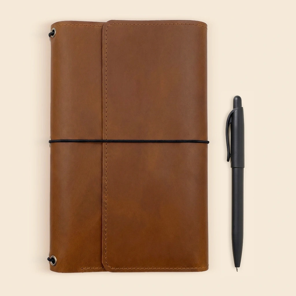 Leather journal holder featuring organized interior layout for work and travel essentials.