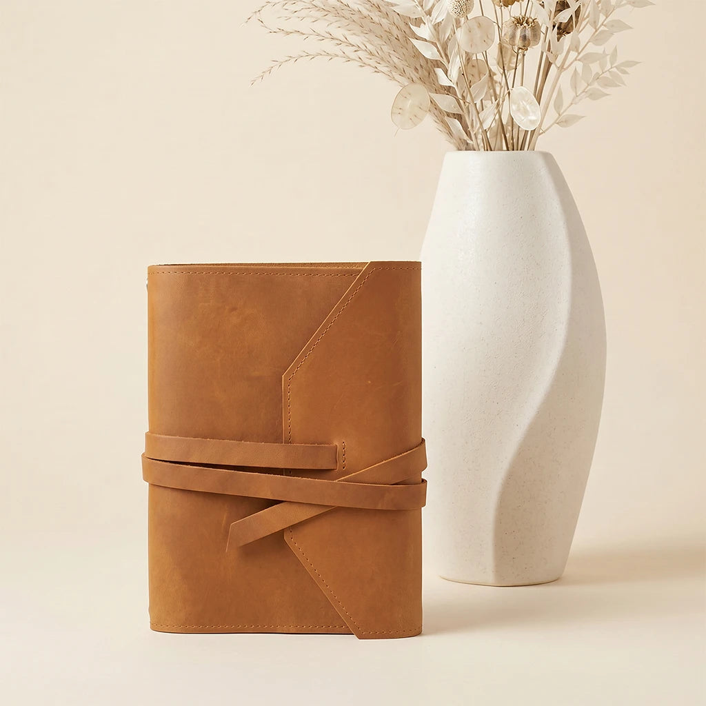 Refillable notebook sleeve crafted to protect journals and hold a pen.