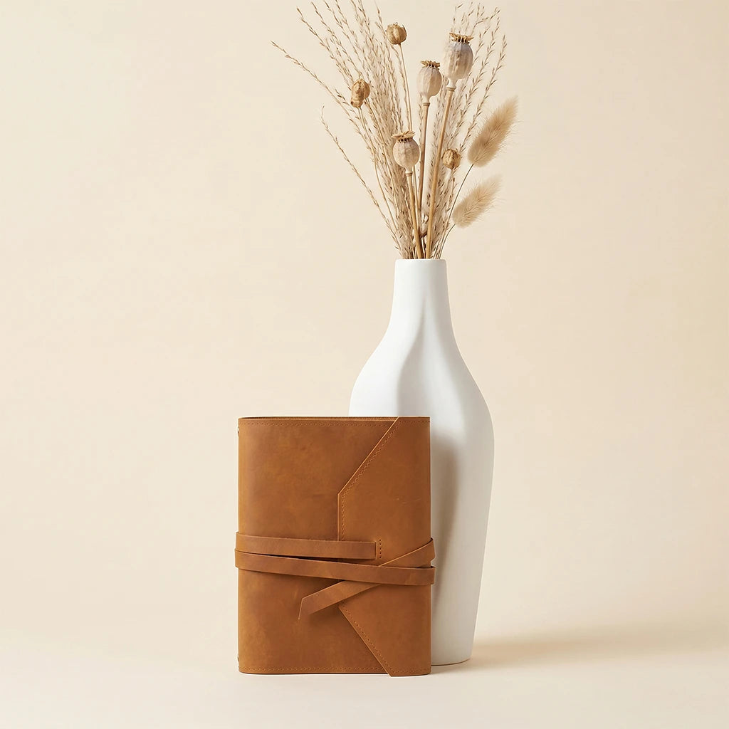 Refillable journal cover in genuine leather with pen holder and elastics.