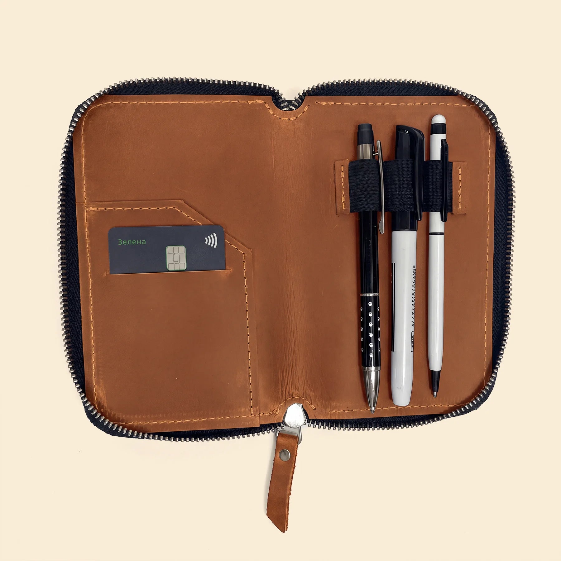 Genuine leather pen holder with zipper designed for everyday office and school use.