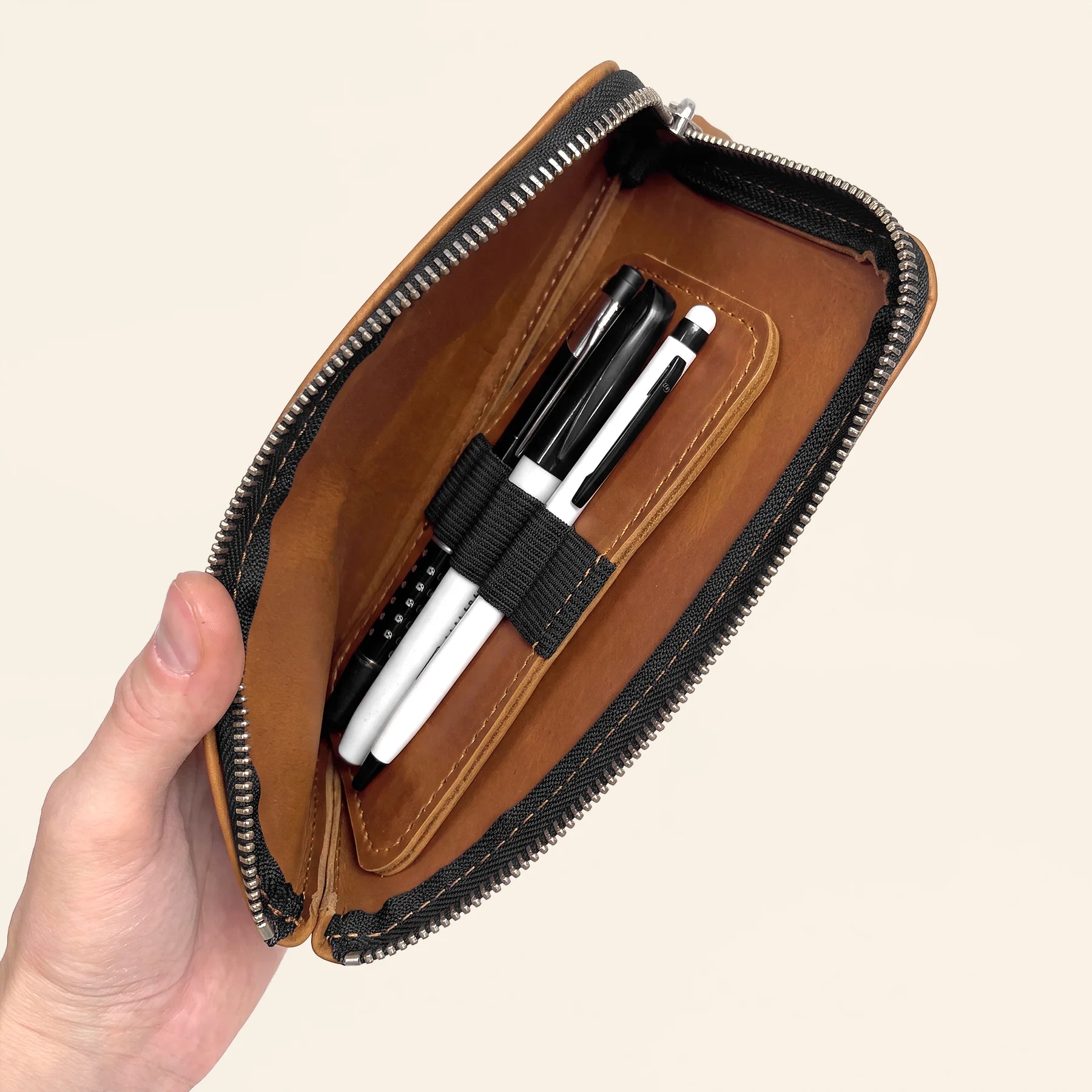 Leather stationery travel case featuring zip closure and premium handcrafted quality.
