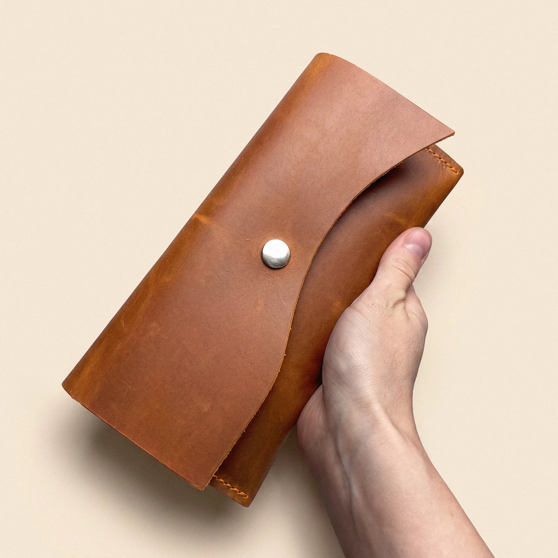 Handmade leather wallet featuring three card slots and a spacious bill pocket