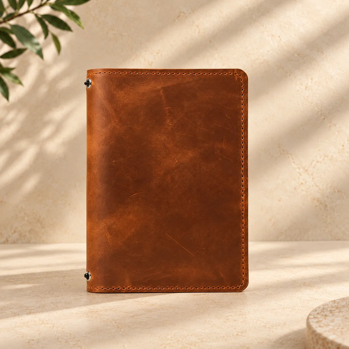 Handmade genuine leather notebook holder featuring two elastic bands and interior storage pockets.