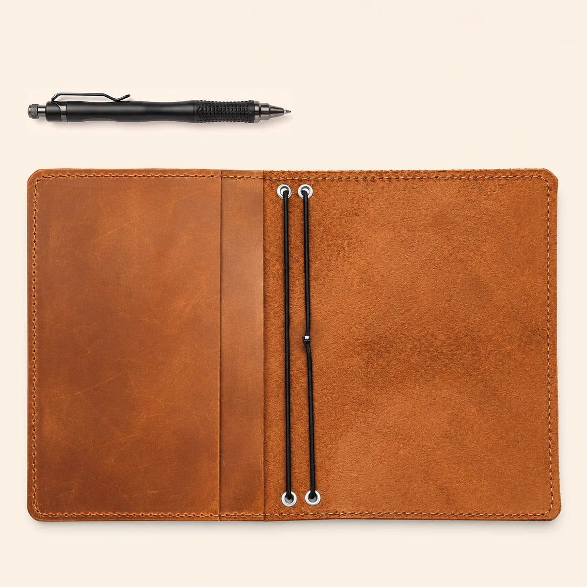 Handmade leather notebook holder featuring authentic grain, dual elastics, and inner compartments