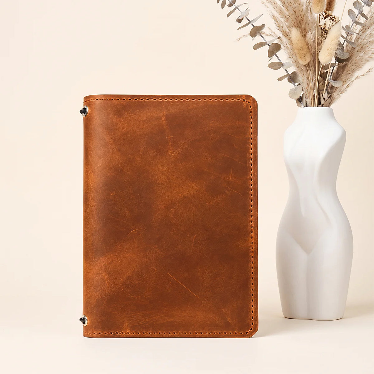 Handmade natural leather journal cover with two bands and organized interior pockets