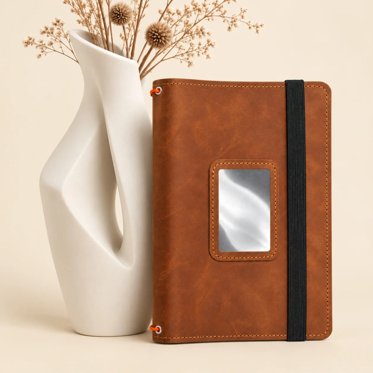 Genuine leather notebook case featuring three secure bands and neatly arranged inner pockets.