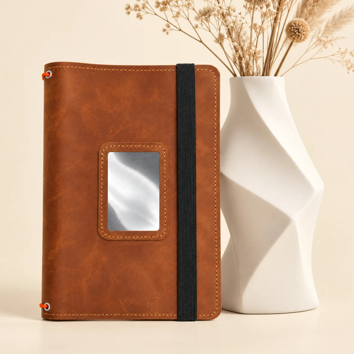 Genuine leather journal cover featuring three flexible straps and organized pockets for small essentials.