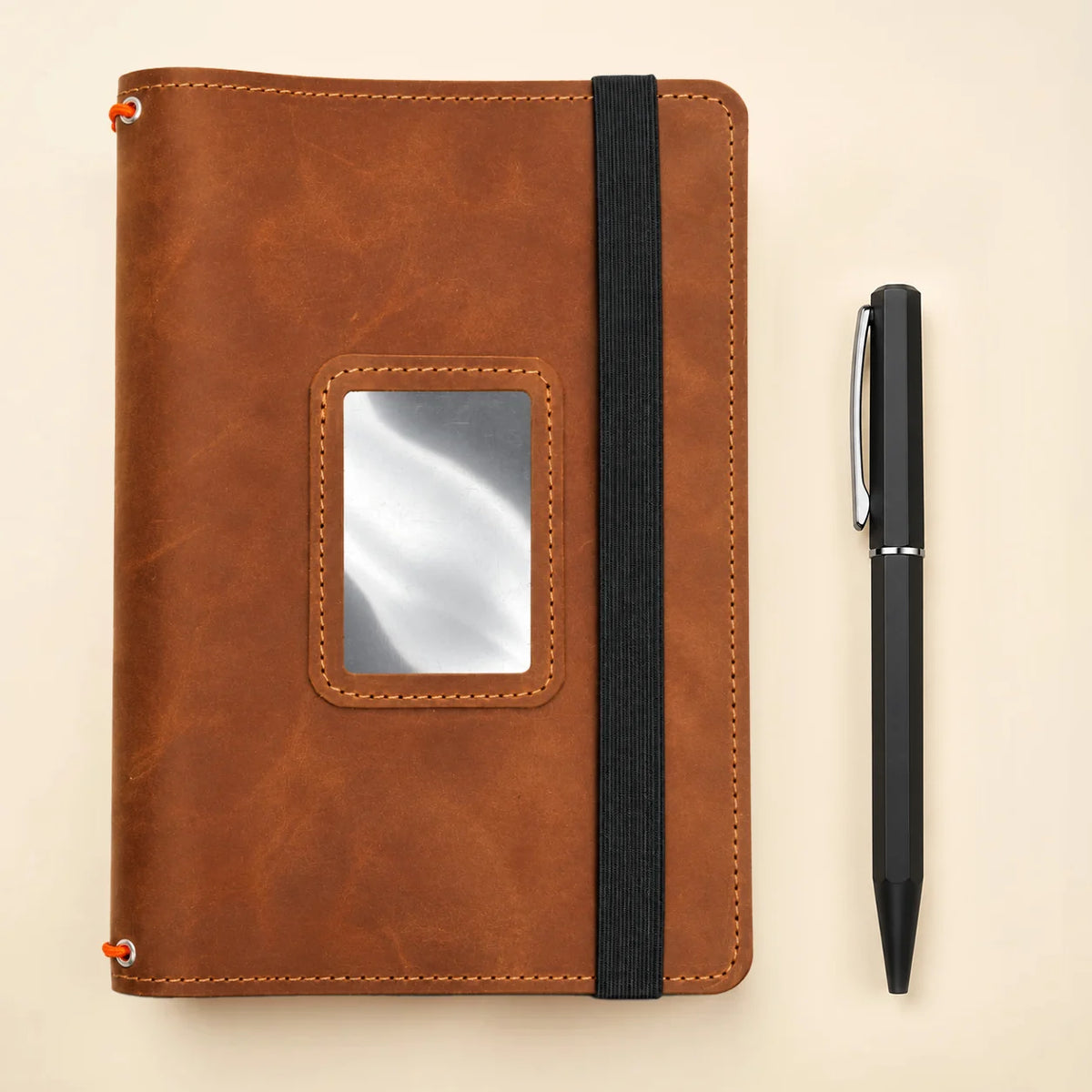 Natural leather notebook organizer with three secure bands and several interior storage spaces.