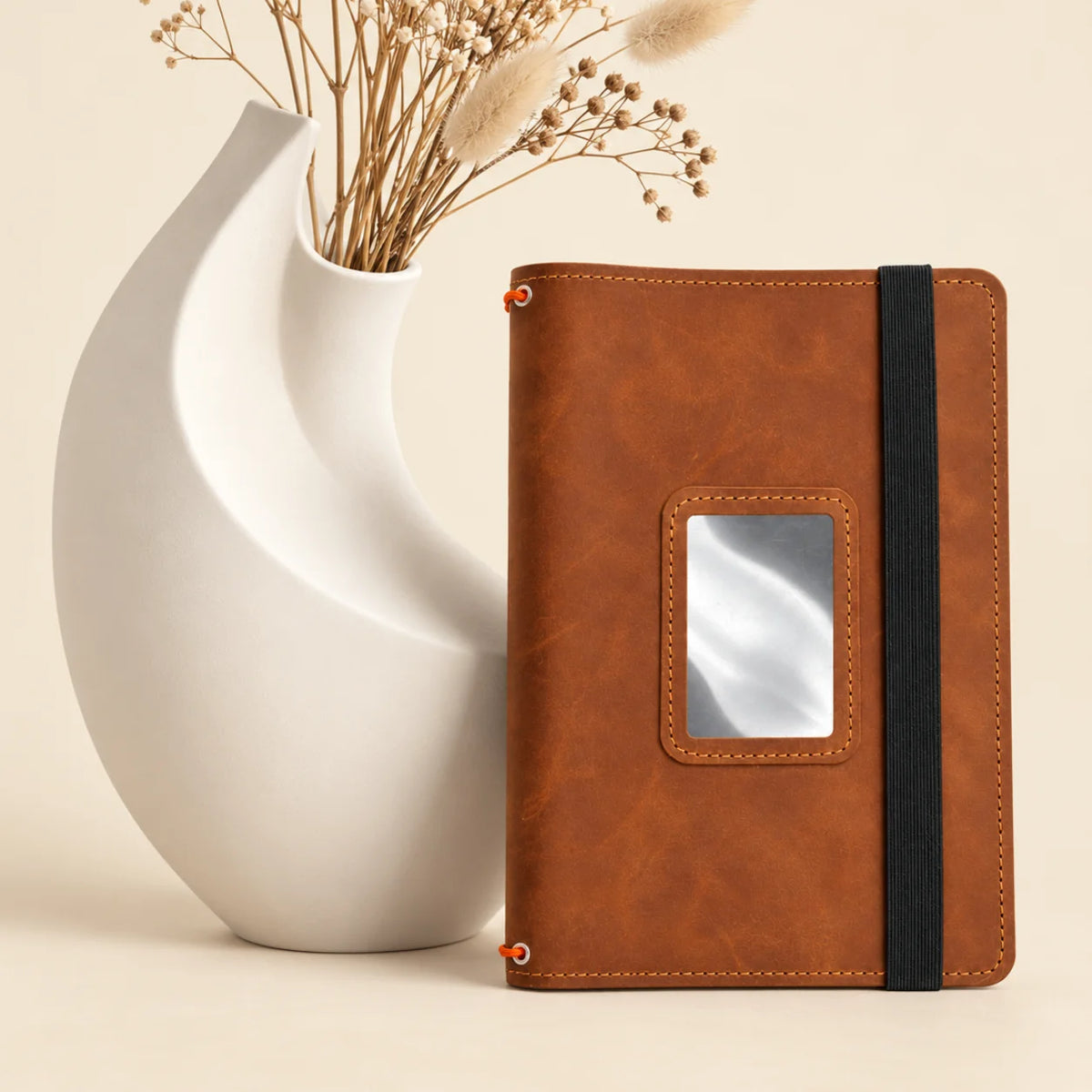 Genuine leather journal case showing three elastic notebook straps and practical storage pockets.
