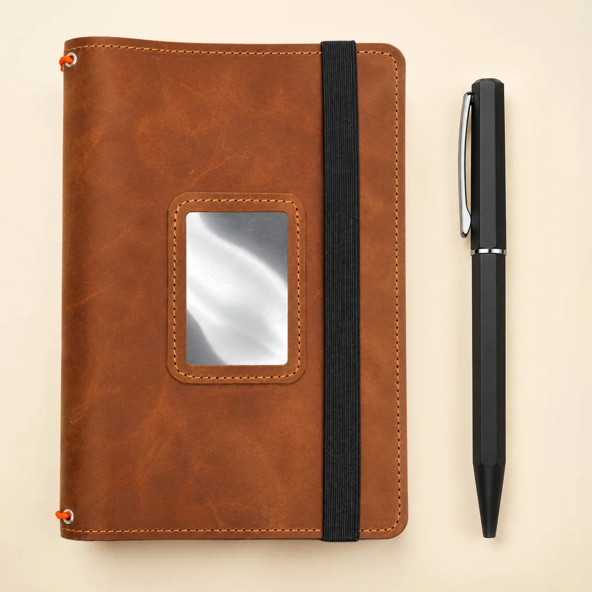 Handmade natural leather journal cover with three elastic bands and spacious interior pockets.