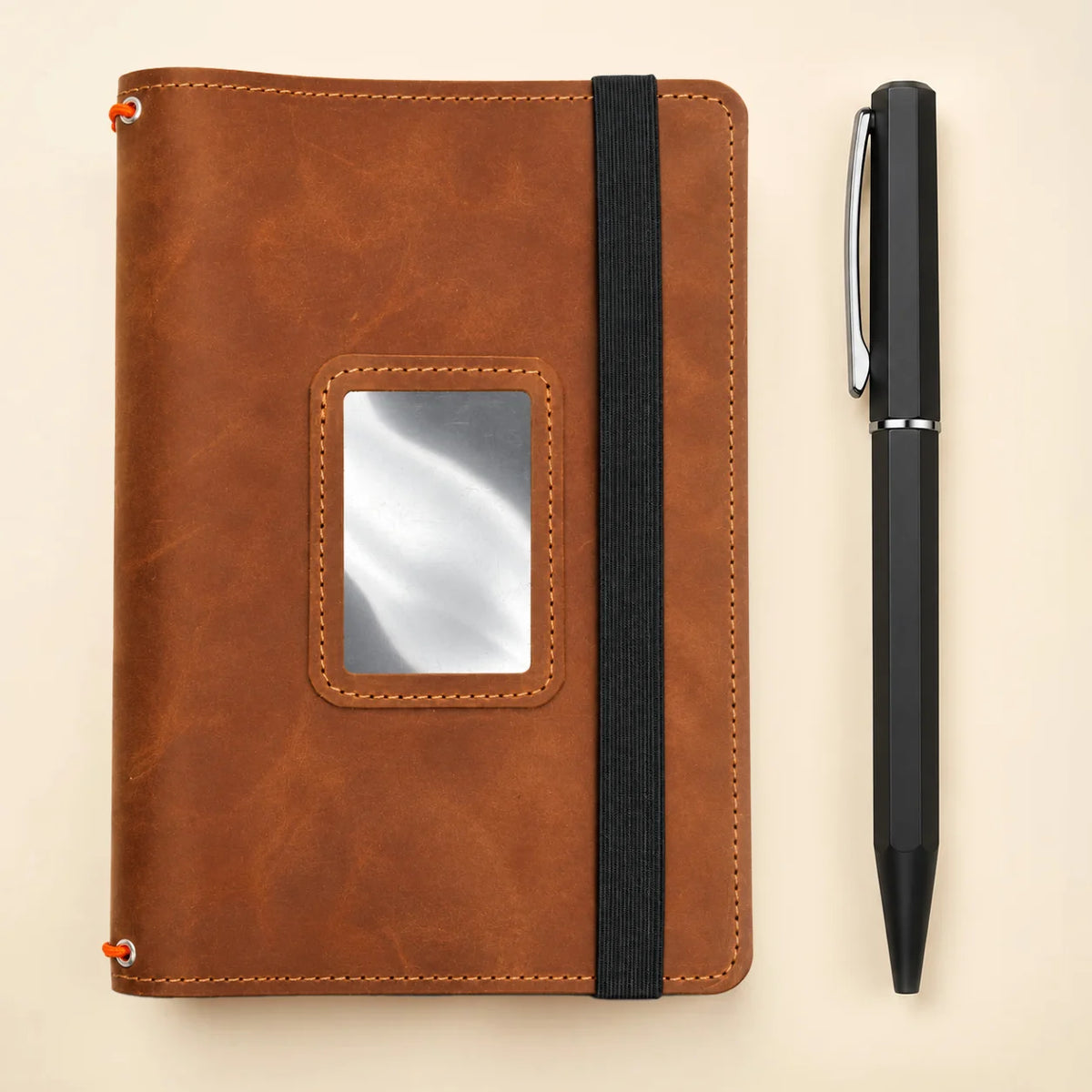 Leather notebook cover with three elastic bands and convenient pockets for stationery.