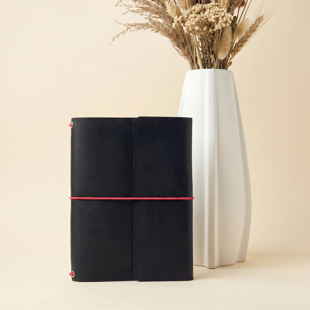 Soft leather notebook cover with elastic closure, storage pockets, and pen loop