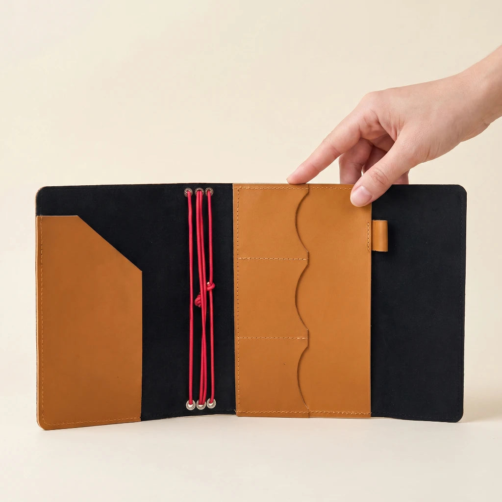 Artisan leather notebook cover with elastic bands, card pockets, and pen holder