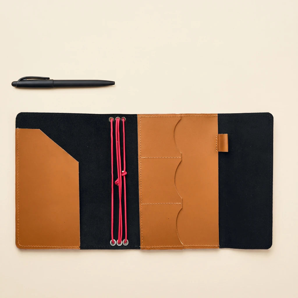 Refillable notebook cover made from leather with elastic straps and organizer pockets