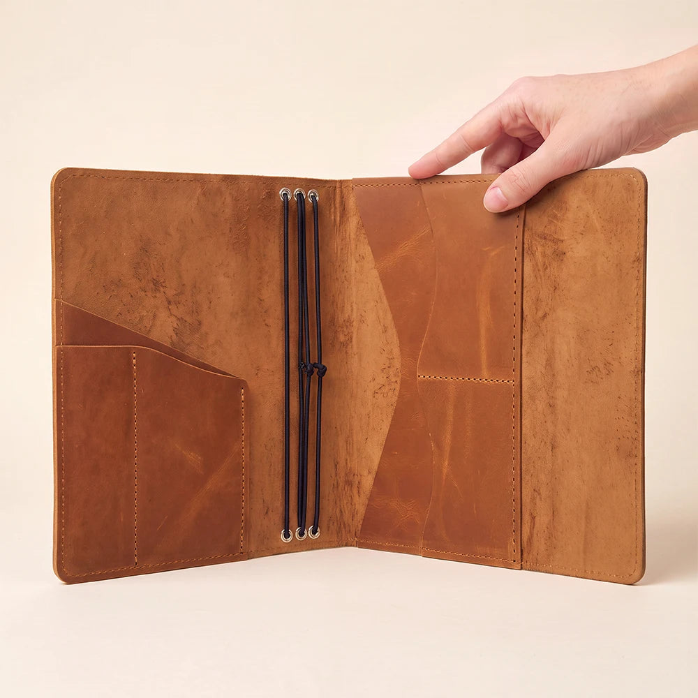 Leather notebook organizer offering refillable functionality and convenient storage for everyday essentials.
