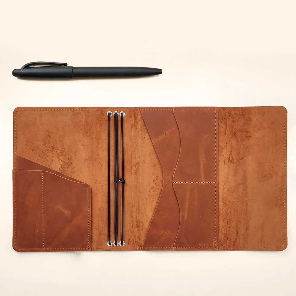 Handmade genuine leather planner cover with refillable notebook inserts and organized storage compartments.