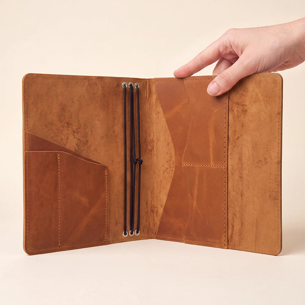 Leather refillable notebook cover with handcrafted quality, pen holder, and spacious inside storage.
