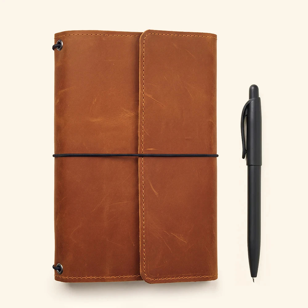 Leather notebook organizer crafted with refillable insert system and premium handmade finish.