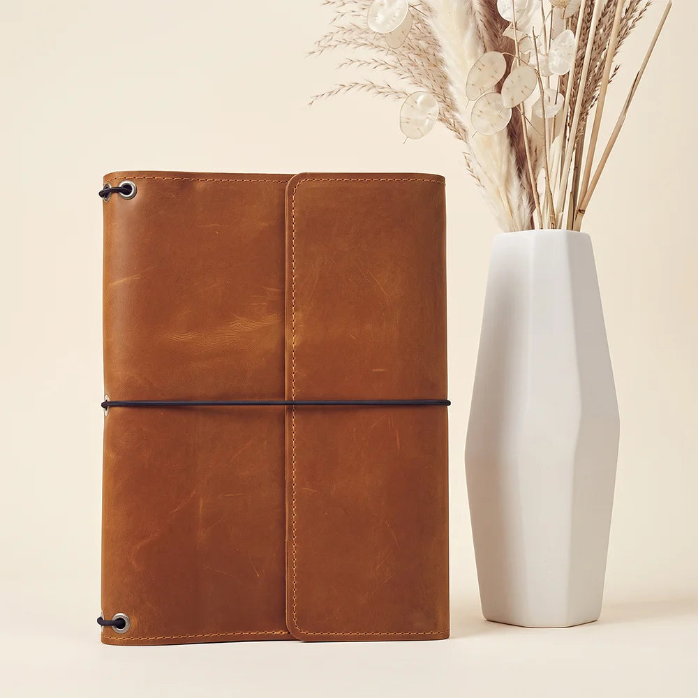 Handmade leather planner organizer crafted for lasting durability and everyday writing convenience.