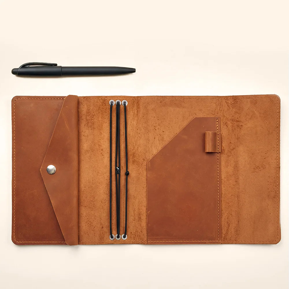 Handmade leather journal portfolio with interior pockets for cards, papers, and everyday accessories.