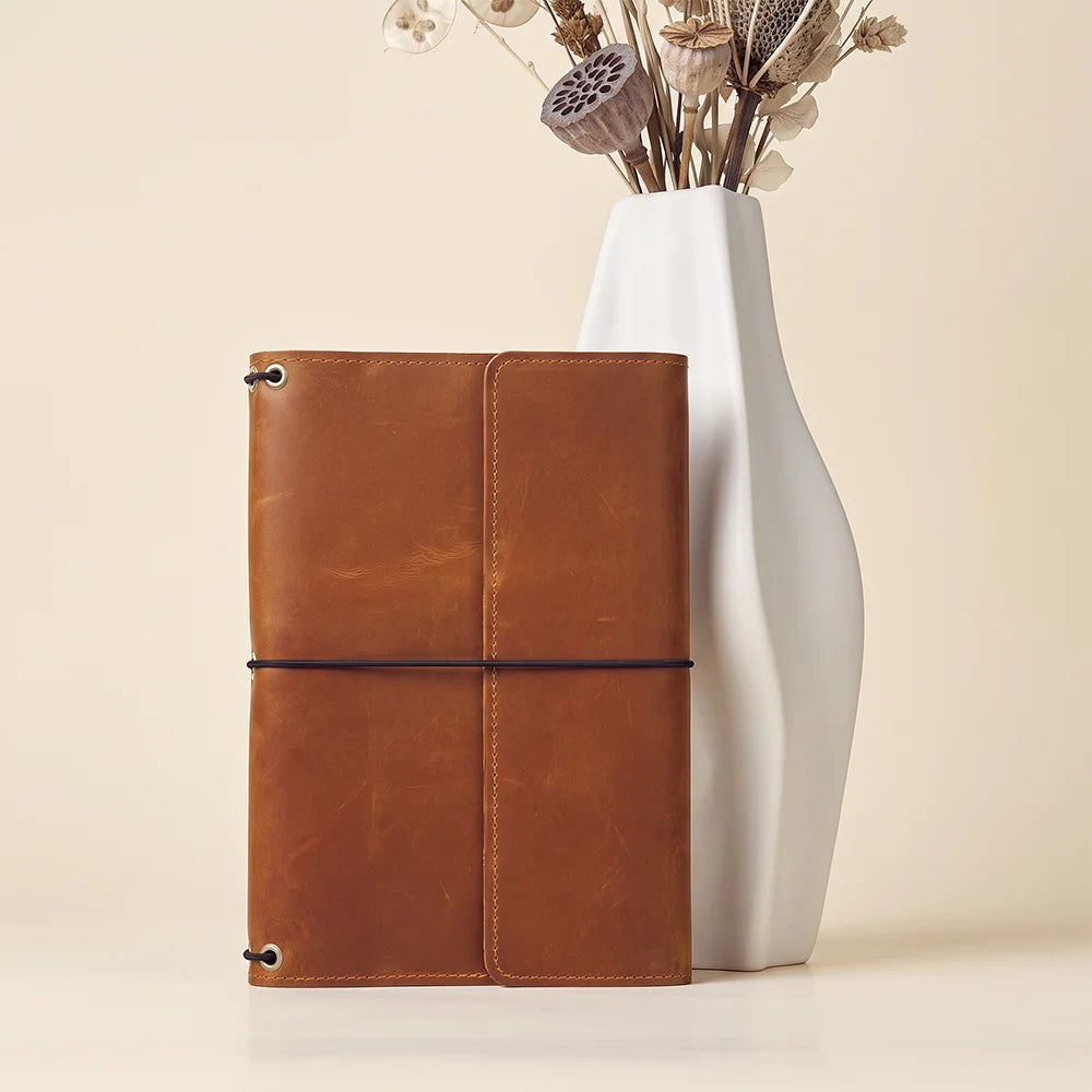 Durable leather notebook cover supporting refillable inserts for long-lasting writing and planning sessions.