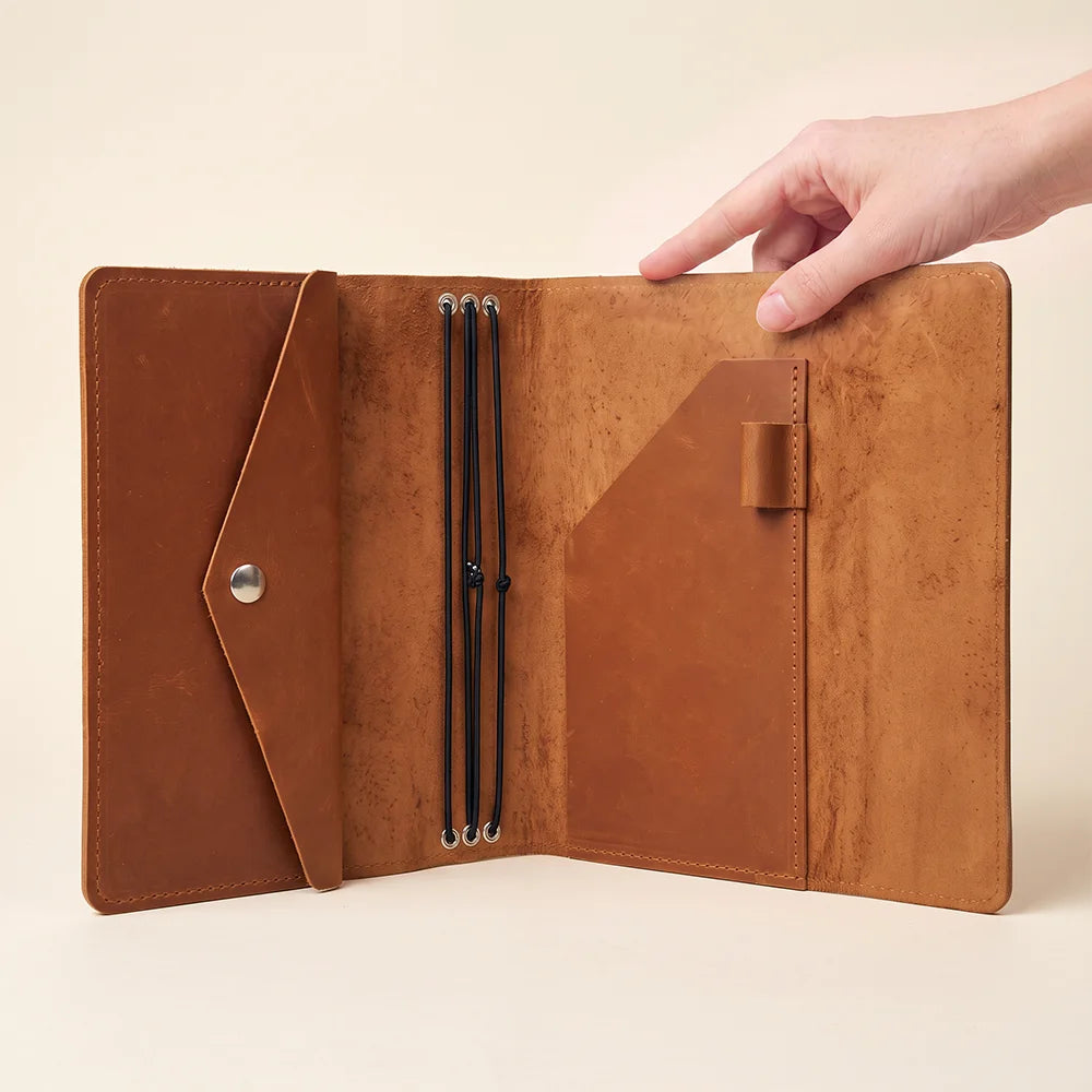 Full grain leather organizer cover with secure elastic notebook system and elegant handcrafted finish.