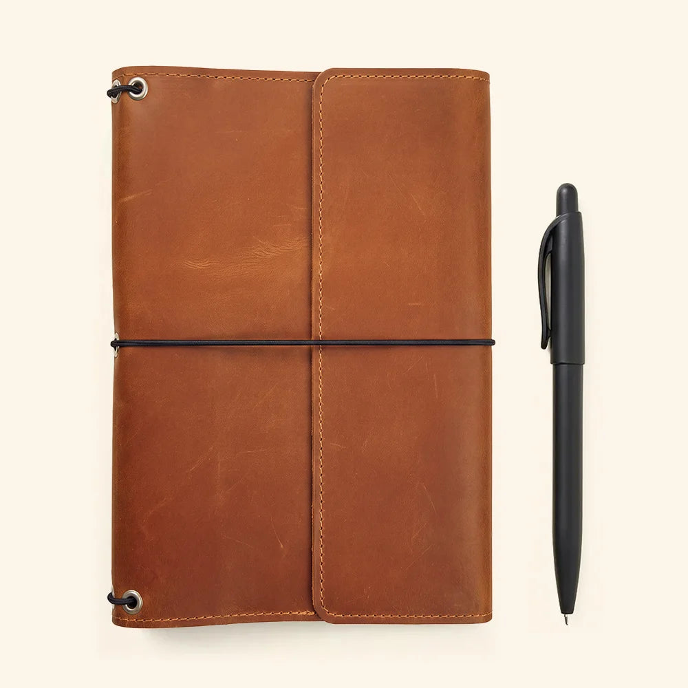 Classic leather journal cover featuring refillable design and convenient pockets for personal essentials.
