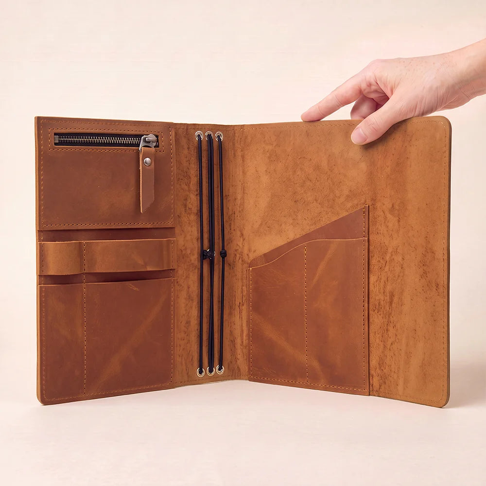 Artisan leather notebook organizer with practical pockets and a dedicated elastic loop for pens.
