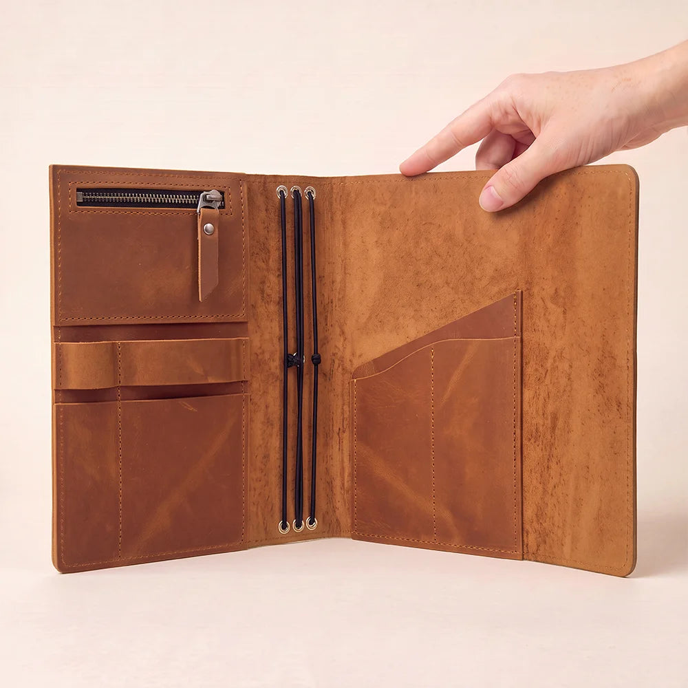 Leather planner sleeve with organized pockets and a practical holder positioned for easy access.