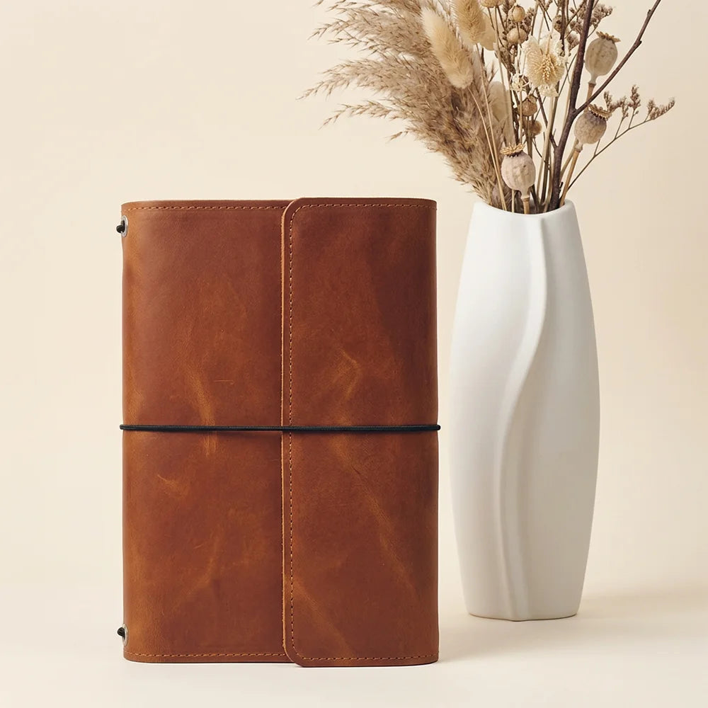 Premium natural leather notebook cover with functional pockets and a convenient elastic pen loop.