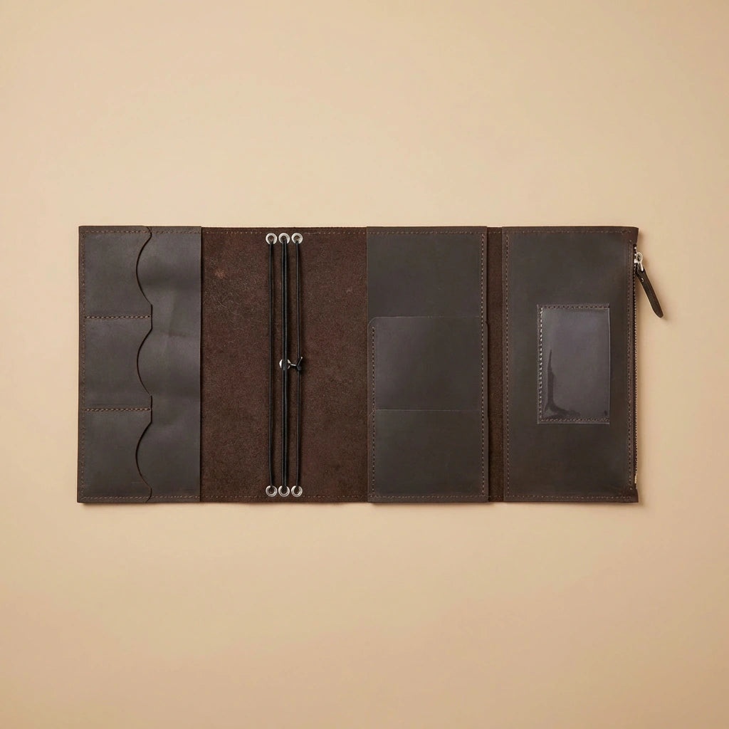 Brown leather journal cover with zipper on a beige background