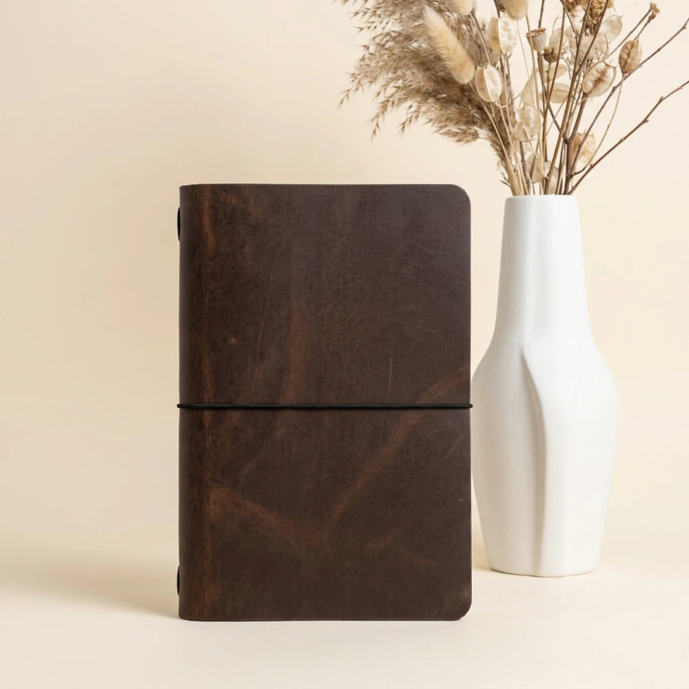 Leather writing cover featuring clean craftsmanship and a single securing loop.