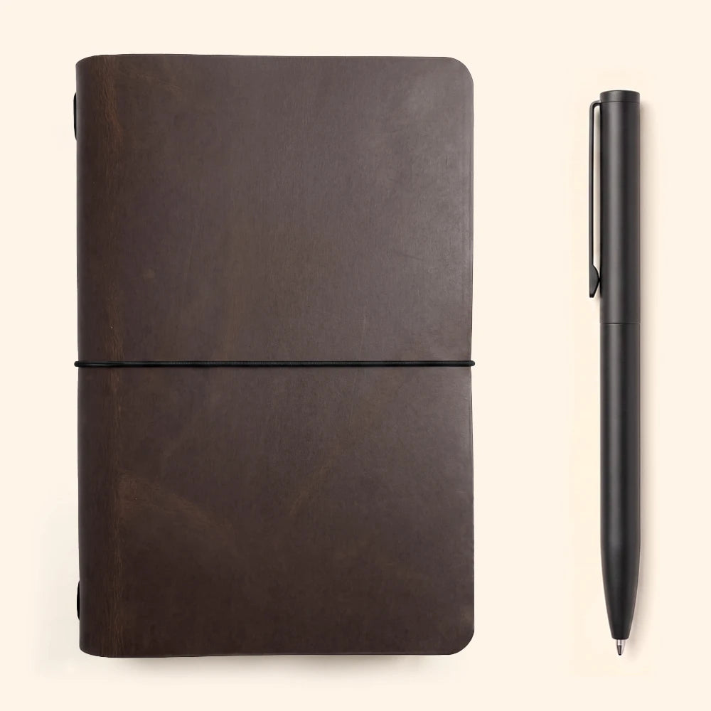 Rustic journal holder with natural leather character and a neatly secured notebook.