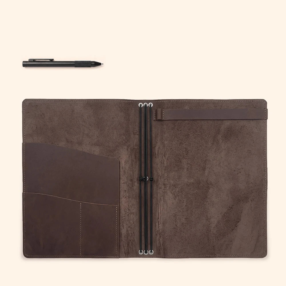Open leather notebook portfolio with secure elastic support and organized paper storage.