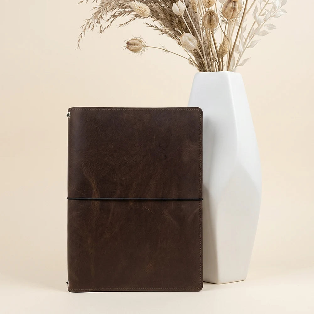 Handmade leather planner cover featuring multiple inserts and a secure sketchbook mount.