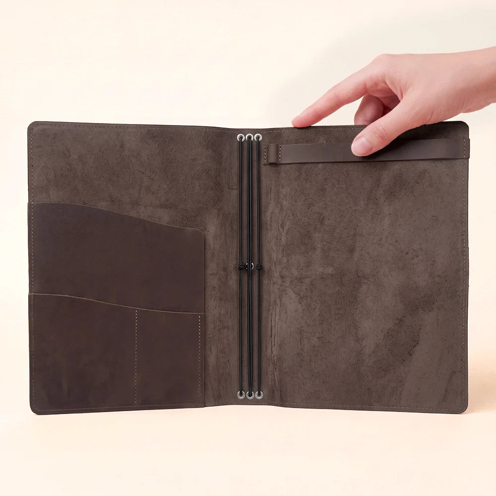 Open refillable journal case crafted from natural leather with functional inner organization.