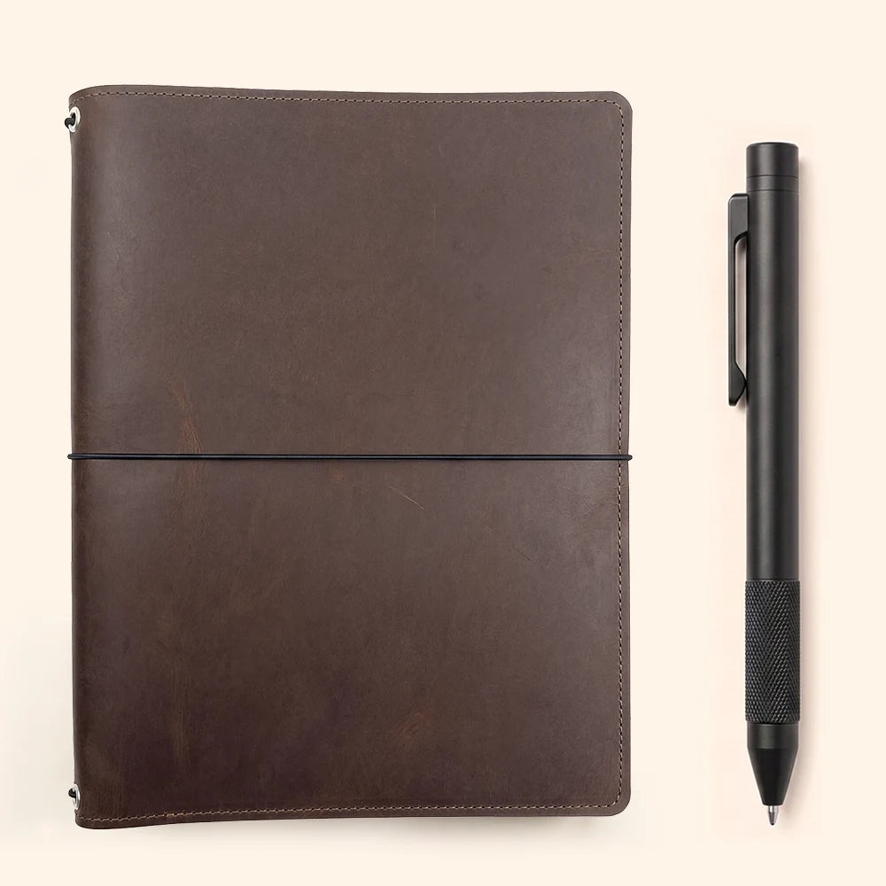 Leather notebook organizer showing three elastic cords and spacious storage compartments.