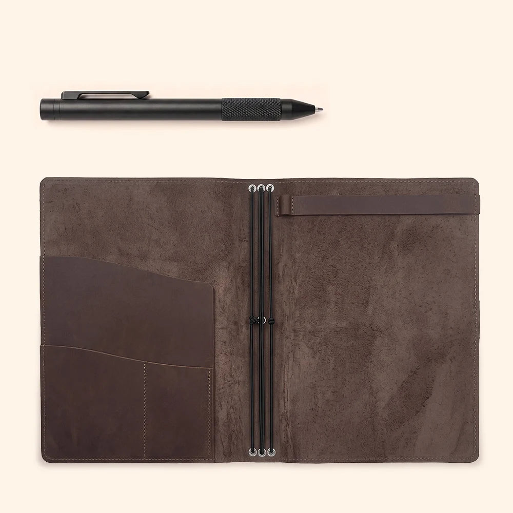 Leather sketchbook cover showing three elastic bands, interior pockets, and notebook fastening.
