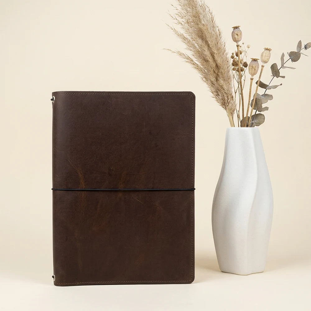 Handmade genuine leather notebook cover offering versatile storage and interchangeable inserts.
