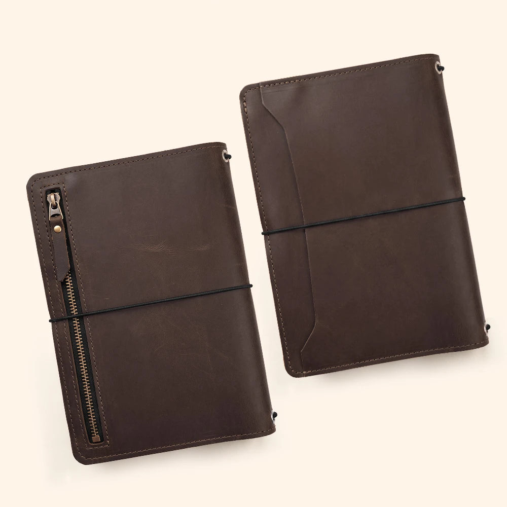 Refillable journal sleeve handcrafted from leather with document compartments and pen loop.