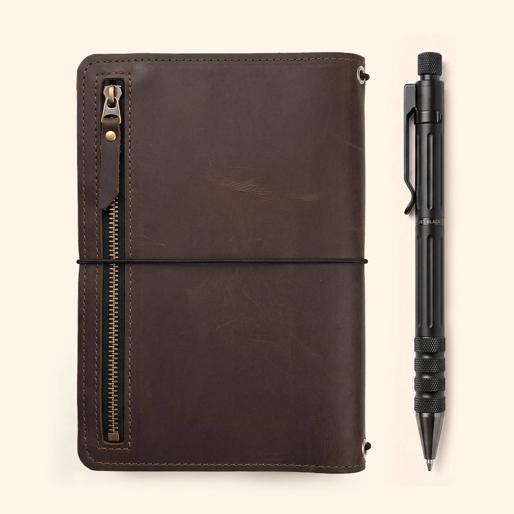 Genuine leather notebook sleeve with organized pockets and secure leather pen loop inside.